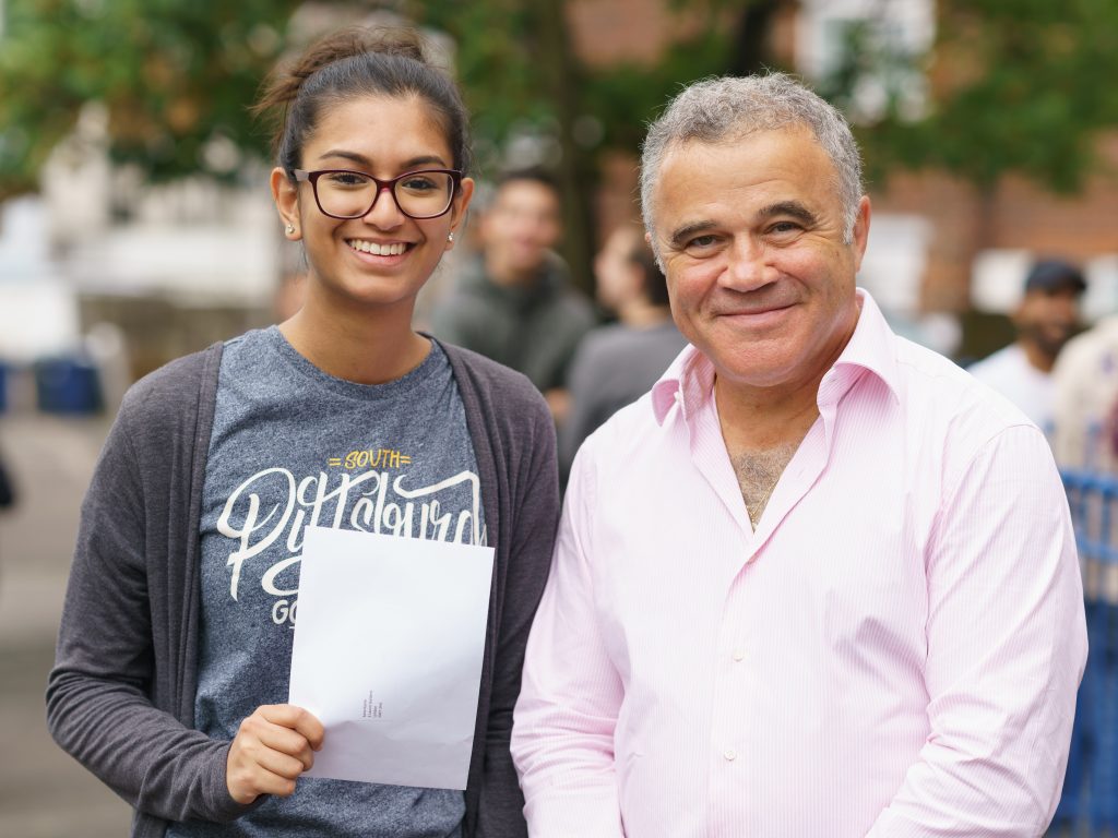 teenage girl holding her exam results