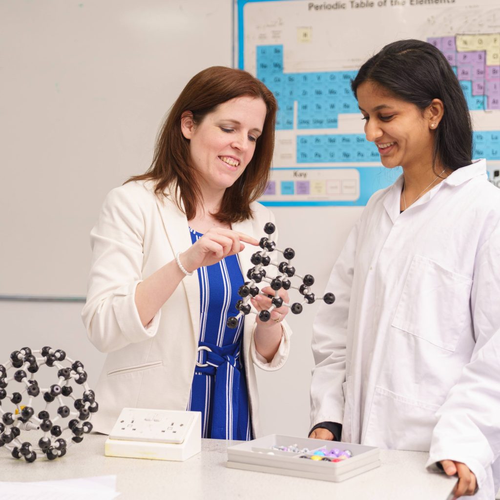 Teacher and her student in the science lab