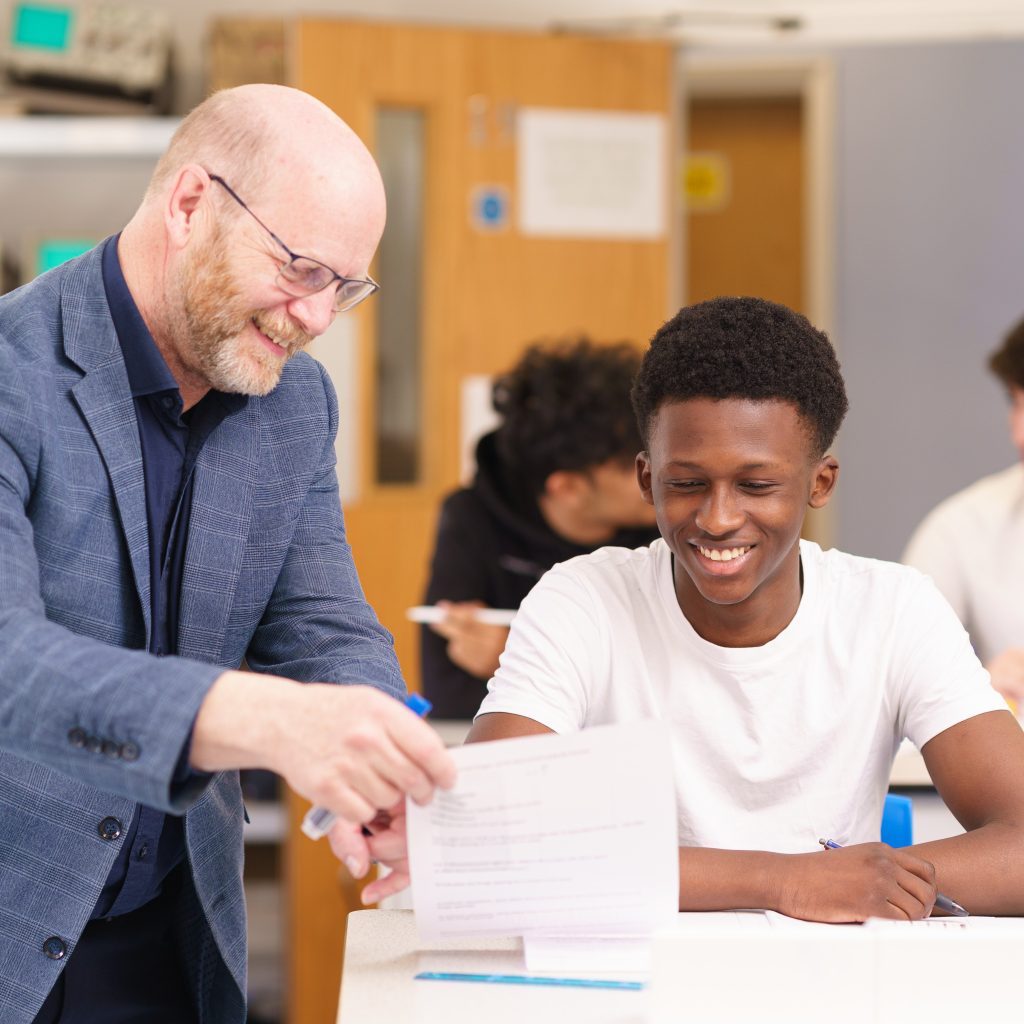 teacher assisting a student