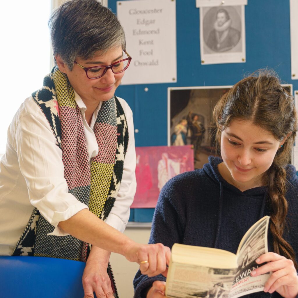 Teacher explaining something to a student