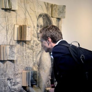 student looking at an art piece