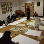 children sat on the floor with flip chart paper