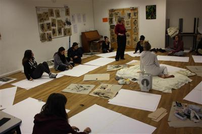 children sat on the floor with flip chart paper