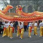 children holding up and waving a dragon