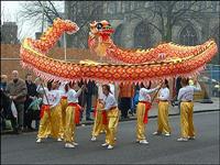 children holding up and waving a dragon