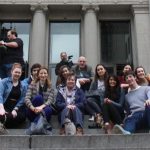 pupils and teachers sat on stairs