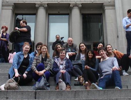 pupils and teachers sat on stairs