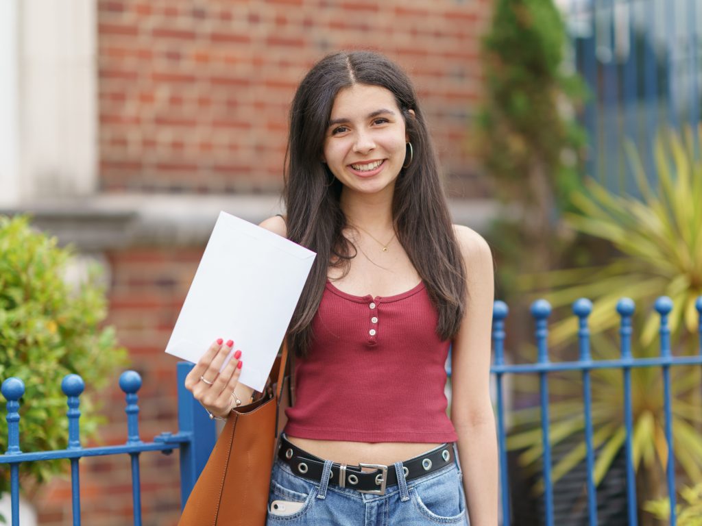girl holding her A level results