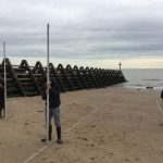 school children on geography trip to beach