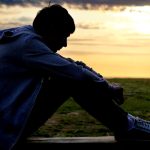 a boy sitting alone