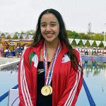 girl with swimming medal