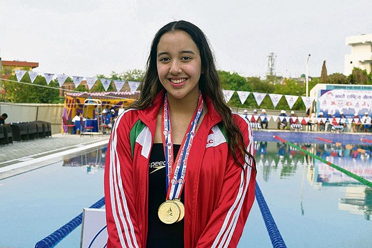 girl with swimming medal