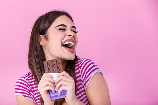 Girl smiling with a chocolate bar in their hands