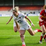 England rugby player running across the pitch
