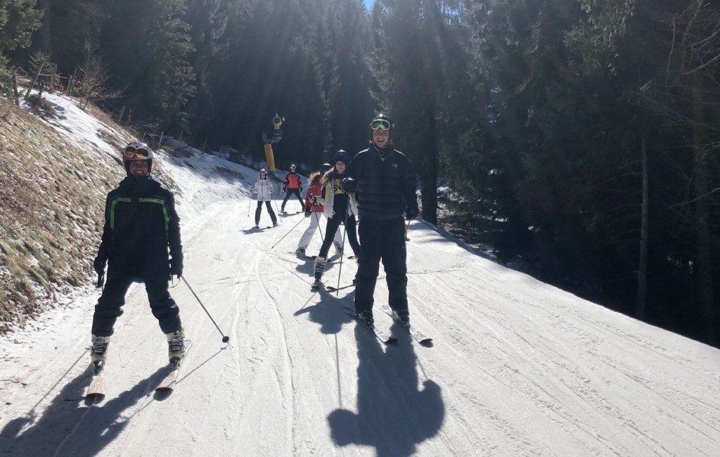 Students going down a ski slope together