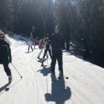 Students going down a ski slope together