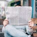 person holding a newspaper