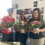 students holding flowers