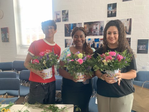 students holding flowers