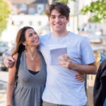 student holding his exam results