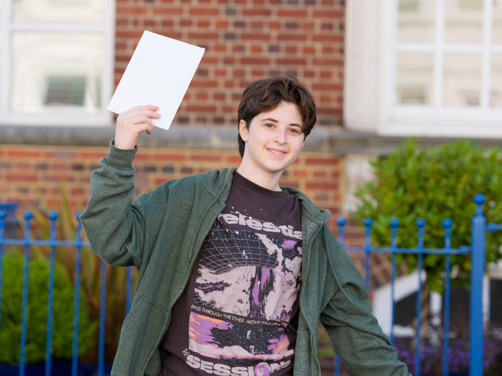 student holding his exam results