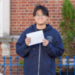 student holding his exam results
