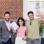 students holding their results