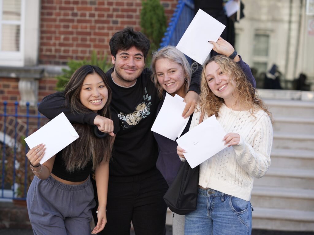 students holding their results