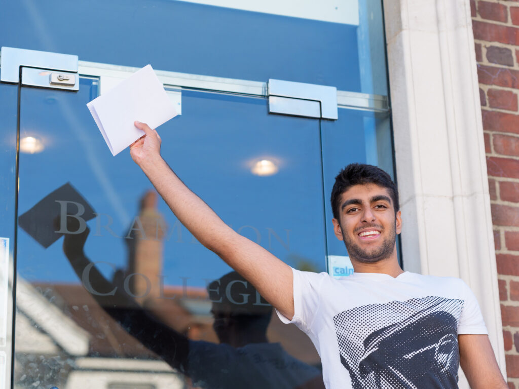 student holding his exam results