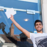 student holding his exam results