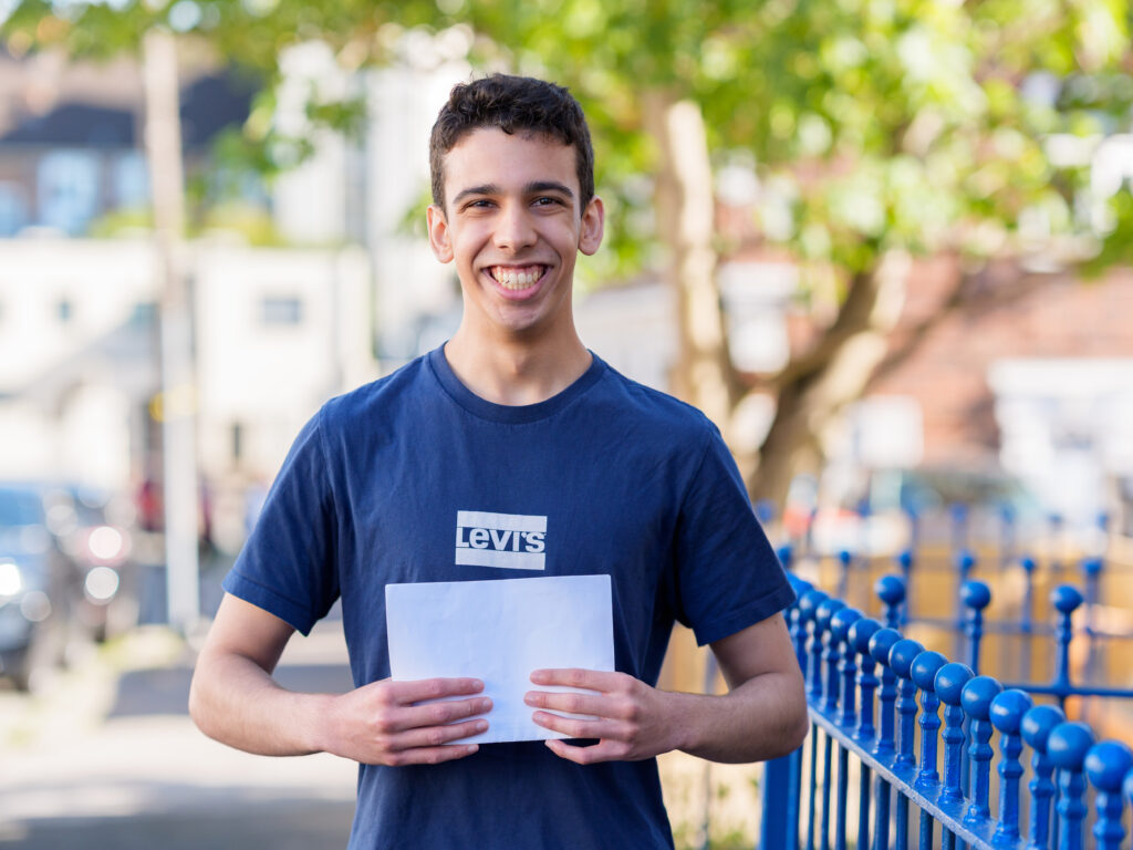 student holding his exam results