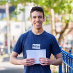 student holding his exam results